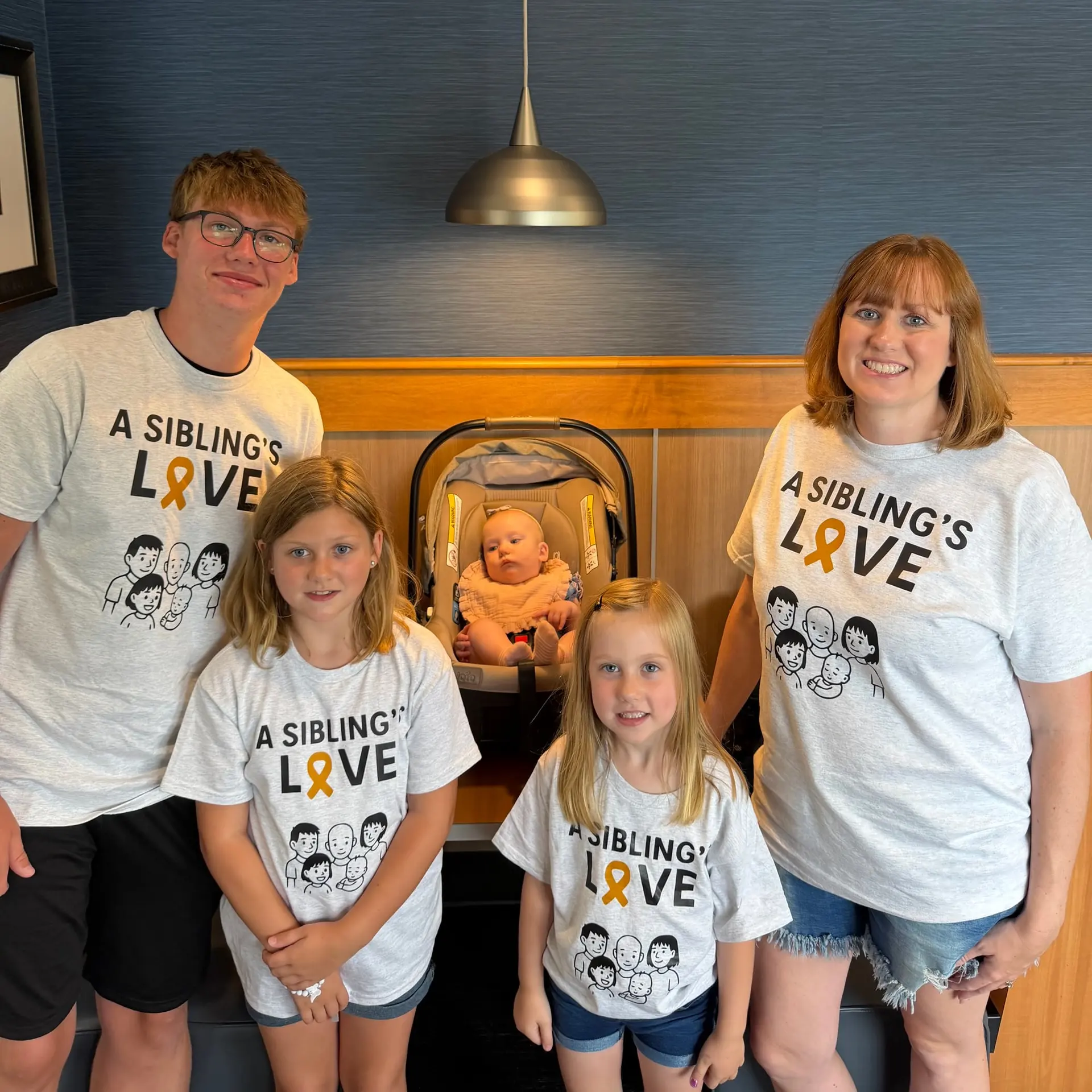 Gavin's mom and siblings wearing matching A Sibling's Love shirts at Culver's Share Night